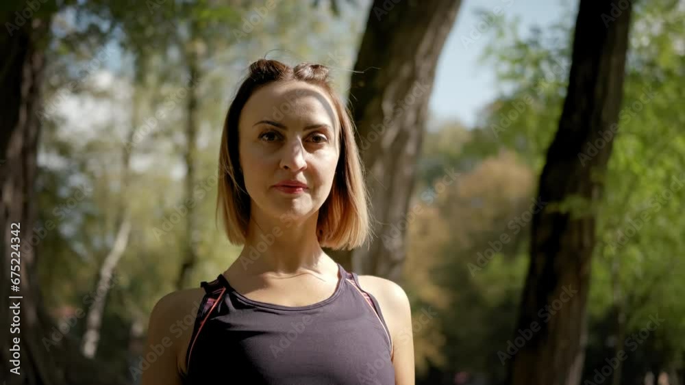Portrait of a young woman doing exercises in nature Portrait of a young woman doing exercises in nature