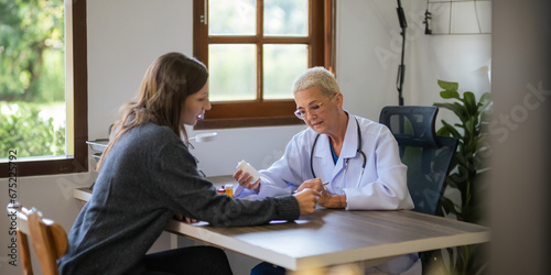 Medicine, healthcare and people concept female doctor with medicine bottle talking to women patient at hospital