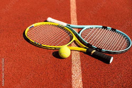 tennis racket and balls on the tennis court © Angelov