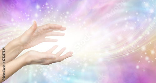 Gentle Lightworker Healing Hands and white light message banner - female hands with sparkling energy vibes against a pastel coloured ethereal shimmering background with copy space spiritual message
 photo