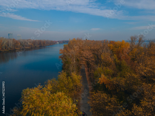 The rowing canal spit on Pobeda in the city of Dnipro from above. River View. Autumn colors. Drone photography. A place for a walk in the city. © Denis Chubchenko
