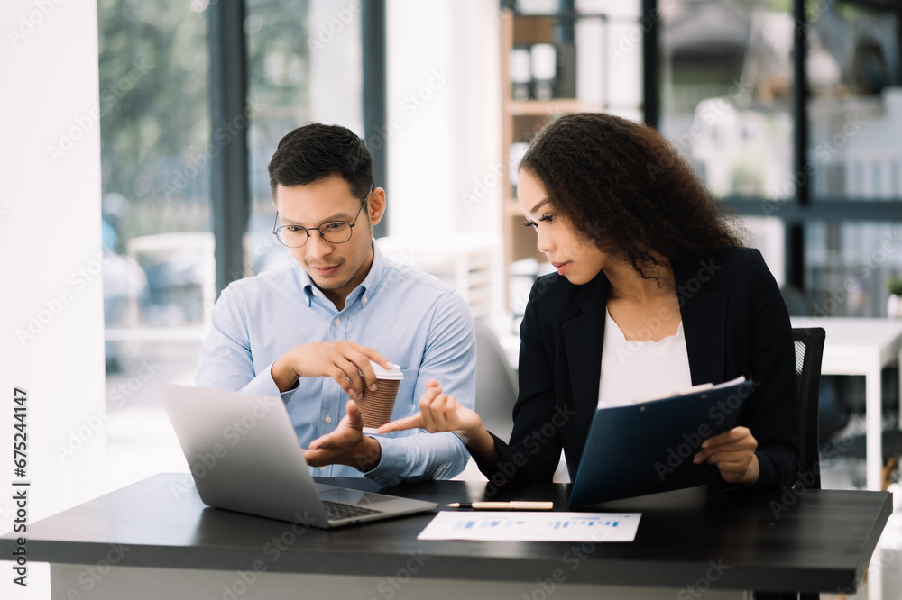 Two Asian businesswoman and man discuss investment projec with tablet laptop computer. Two Asian businesswoman and man discuss investment projec with tablet laptop computer.
