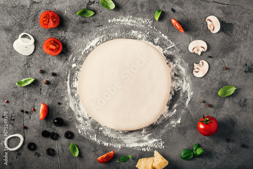 The ingredients for homemade pizza on wooden background