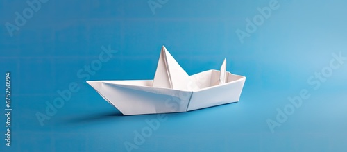 The white origami boat expertly crafted by hand sailed across the paper sea as a miniature ship embodying the concept of travel and adventure captivating the imaginations of kids with its is