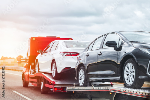 Reliable Towing and Recovery Services: 24-7 Assistance for Vehicle Breakdowns and Accidents. Emergency roadside assistance on the highway. side view of the flatbed tow truck photo