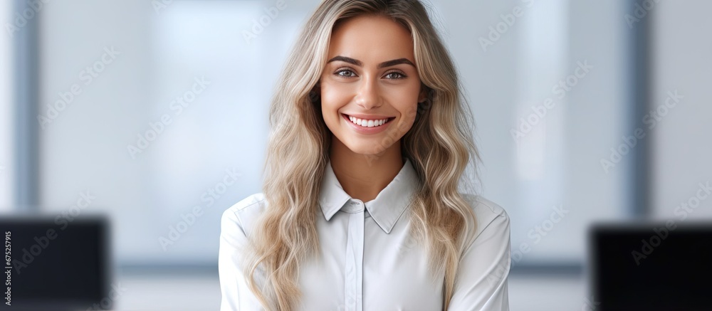 The happy woman employee is seen in an isolated office with a white background holding a business hand portrait wearing a smile of success on her face The happy woman employee is seen in an isolated office with a white background holding a business hand portrait wearing a smile of success on her face
