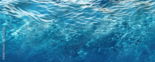 Blue sea water surface with sun glare and ripple background