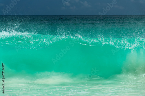 Powerful giant big wave breaking on the shore in the Seychelles, ocean abstract