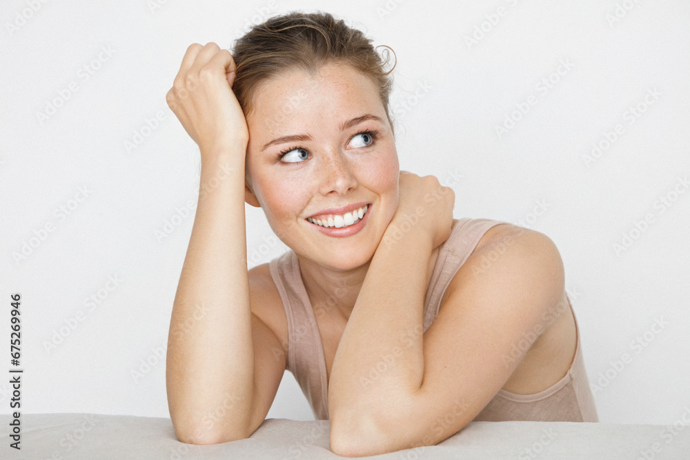 Young Woman Leaning on Elbows, Smiling
Young Woman Leaning on Elbows, Smiling