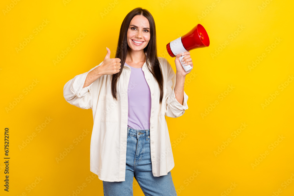 Photo of cheerful pretty woman with brunette hair dressed white jacket hold megaphone show thumb up isolated on yellow color background Photo of cheerful pretty woman with brunette hair dressed white jacket hold megaphone show thumb up isolated on yellow color background