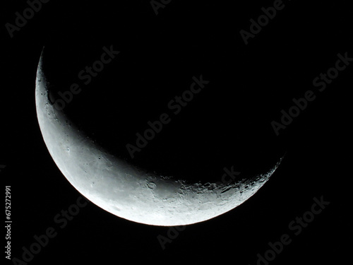moon in wanning crescent phase with dark sky in the background  photo