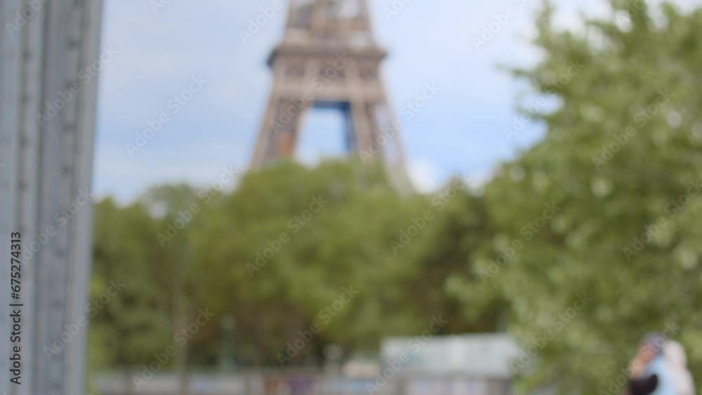Blurred scene of base of Eiffel Tower in spring, Paris. Handheld, shallow focus Blurred scene of base of Eiffel Tower in spring, Paris. Handheld, shallow focus