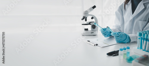 Chemist is chemically analyzing test tubes, Scientist is experimenting with chemicals in the laboratory, Chemist is separating compounds in test tubes with chemical reagents. photo