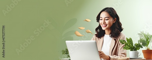 Happy young woman using laptop sitting at desk writing notes. Banner with empty copy space. photo