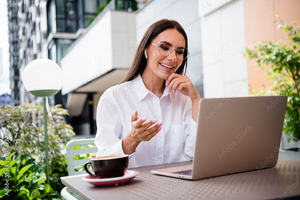 Photo of classy gorgeous real estate agent girl sit street cafe table communicate video call netbook outdoors Photo of classy gorgeous real estate agent girl sit street cafe table communicate video call netbook outdoors