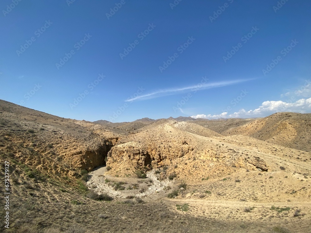 A rocky mountain overlooking a vast desert landscape: Armenia, Angel's Canyon