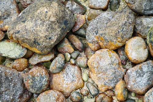 High angle shot of old wet rocks on a beach