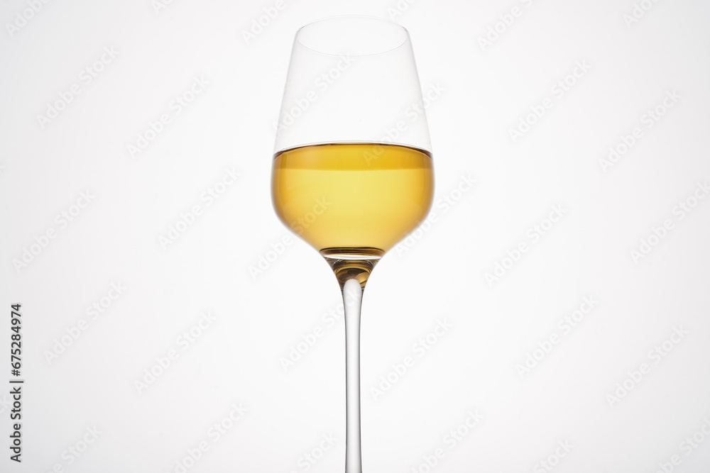 White wine fills half glass. Champagne flute. White wine fills half glass. Champagne flute.