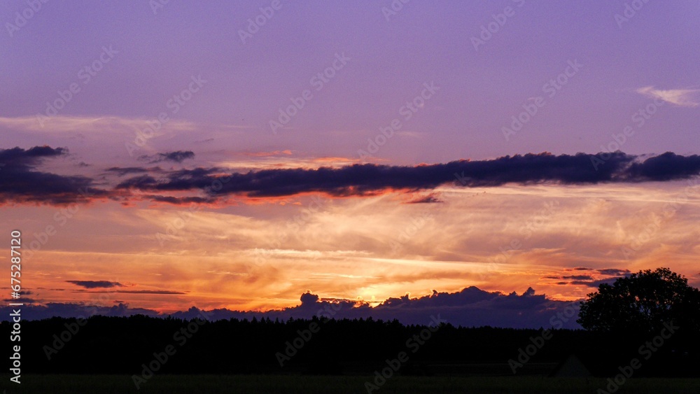 Vibrant, colorful sunset sky with a variety of oranges and purples
