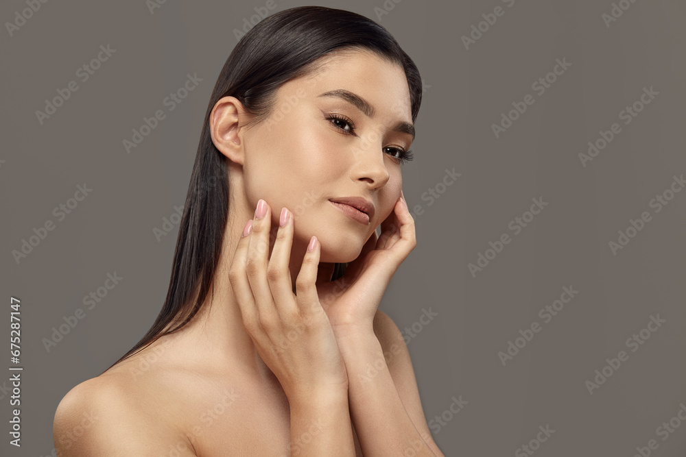 Girl touching her face with hands enjoying soft smooth skin. Girl touching her face with hands enjoying soft smooth skin.
