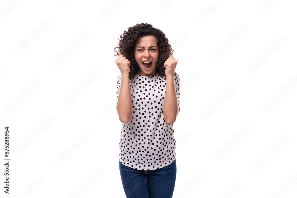 a slender young stylish woman with a curly haircut dressed in a blouse with polka dots feels joy a slender young stylish woman with a curly haircut dressed in a blouse with polka dots feels joy