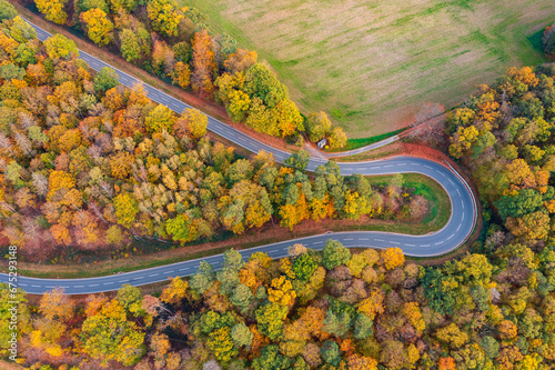Bird's-eye view of a winding road through an autumn forest in the Taunus near Obernhof/Germany on the Lahn © fotografci