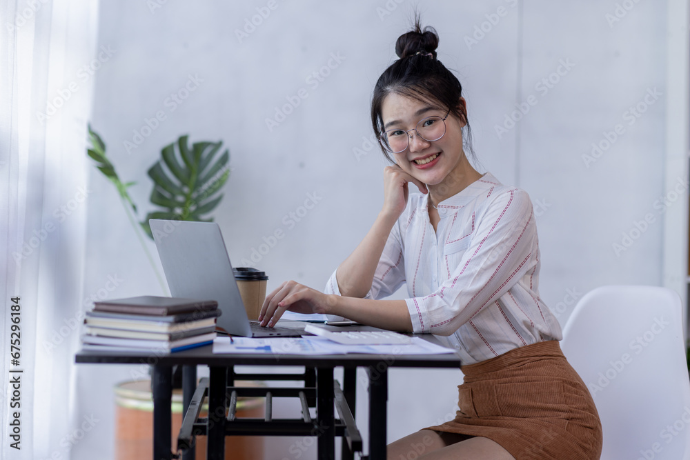 Happy young asian woman drinking coffee relaxing at work, Smiling female enjoying resting sitting on couch in modern office. Happy young asian woman drinking coffee relaxing at work, Smiling female enjoying resting sitting on couch in modern office.
