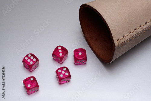 Still life red dice and leather cup on white background
