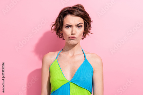 Photo of suspicious funny lady wear green blue tank top looking you isolated pink color background