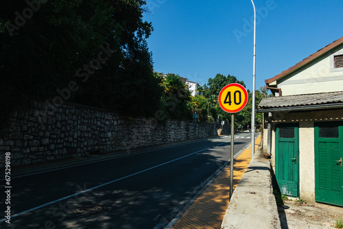 Yellow round 40 km speed limit sign on a road in Croatia on a sunny day photo