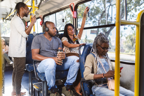 Multiracial passengers inside the bus on an urban route. photo