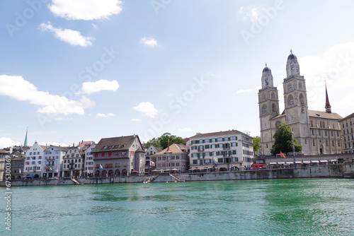 Zurich, Switzerland.. View of the historic city center with famous Grossmunster Cathedral with River Limmat.
