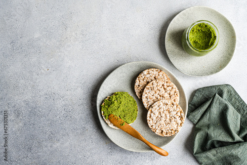 Dieting breakfast with rice bread and spinach pesto pasta-sauce photo