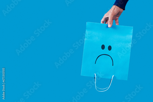 man with a sad shopping bag upside-down photo