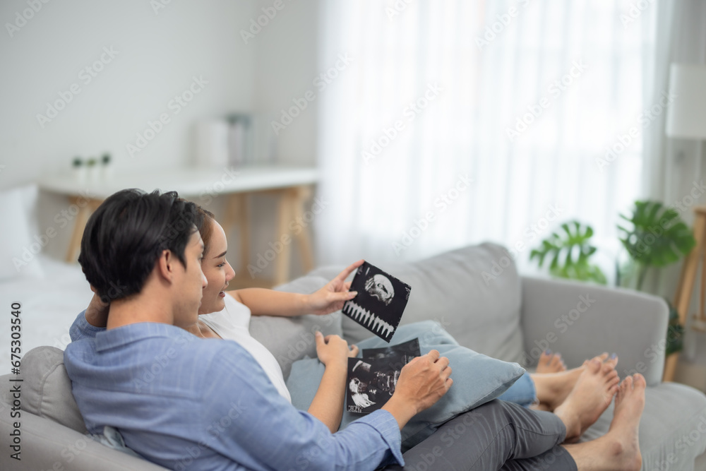 Asian couples joyfully watch ultrasounds, revealing baby's health, gender, strengthening family bonds