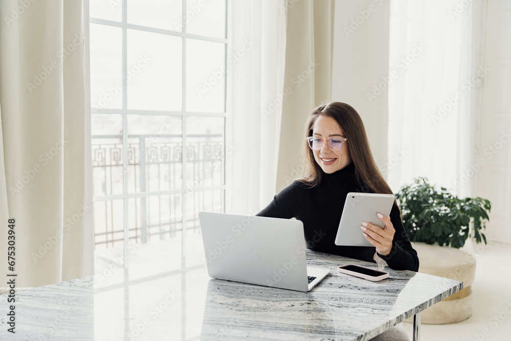 A young woman studying online for free video call uses a computer. A smart creative female designer works in an office alone writing text on a laptop. A young woman studying online for free video call uses a computer. A smart creative female designer works in an office alone writing text on a laptop.