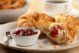 Croissants with strawberry preserves and cup of coffee
