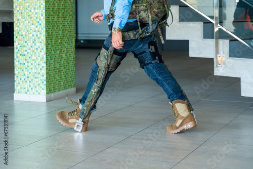Mechanical military exoskeleton to help unrecognizable soldiers and military personnel walking. Camouflage exoskeleton for futuristic high security