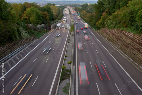 Long exposure photo of traffic with blurred traces from cars, top view. road, cars, blurred traffic, evening, top view. Highway at evening, blue hour illuminated by the traffic of cars