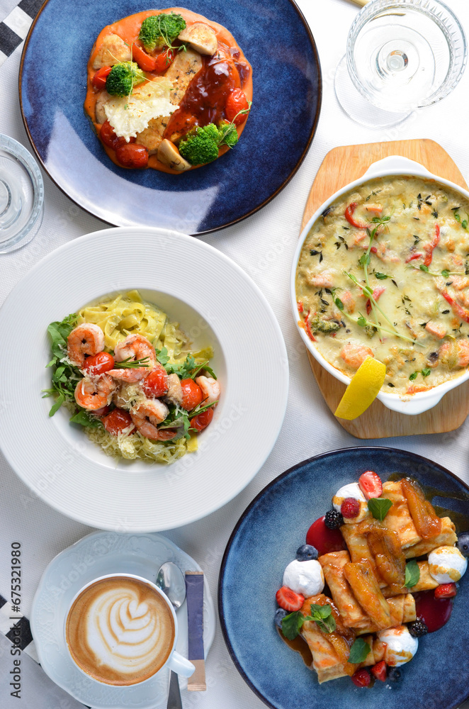 Tasty Restaurant Food Top View, Different Dishes on a Table, Pasta with Shrimp, Salmon Casserole, Chicken Fillet, Sweet Crepes and Coffee Tasty Restaurant Food Top View, Different Dishes on a Table, Pasta with Shrimp, Salmon Casserole, Chicken Fillet, Sweet Crepes and Coffee