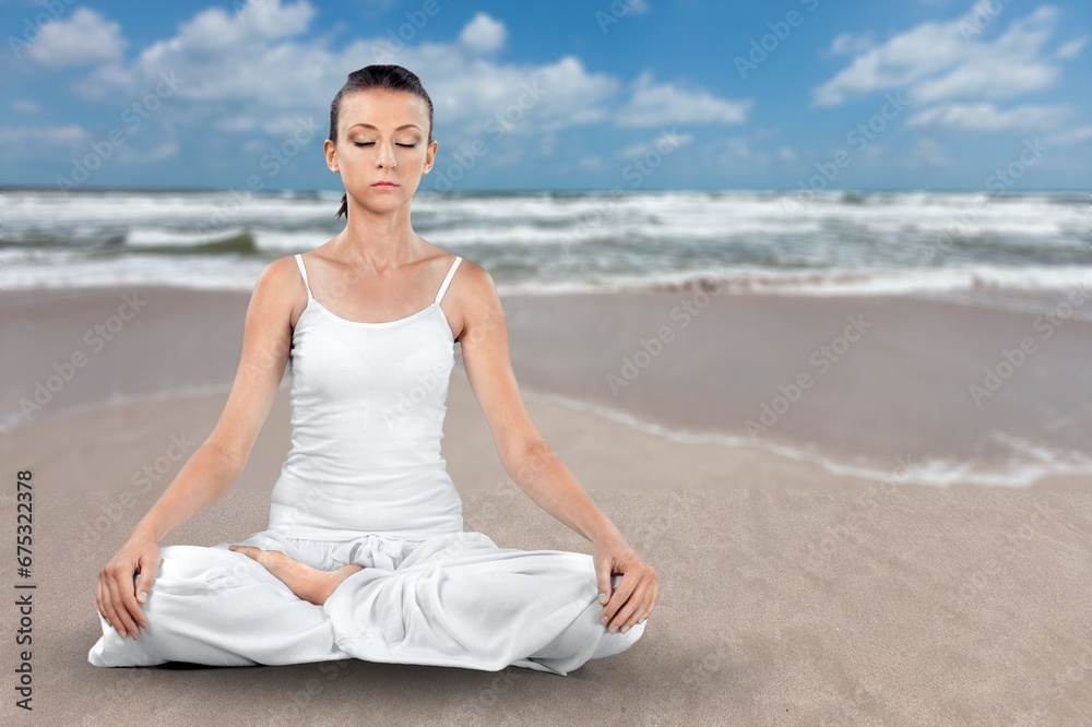 Yoga meditation young woman at seaside