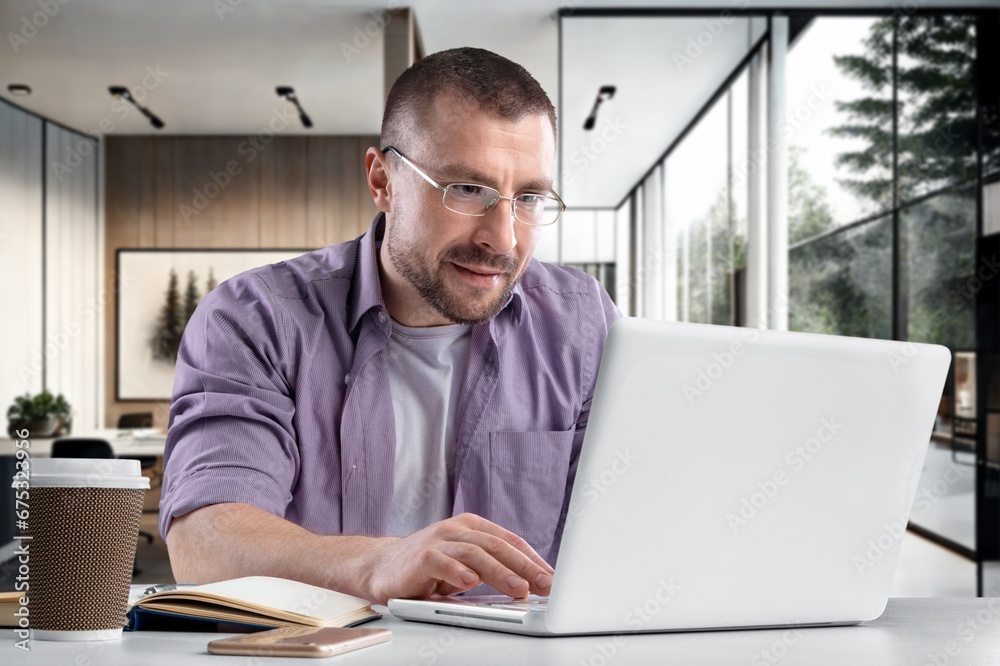 Young businessman using a computer in office, AI generated image Young businessman using a computer in office, AI generated image