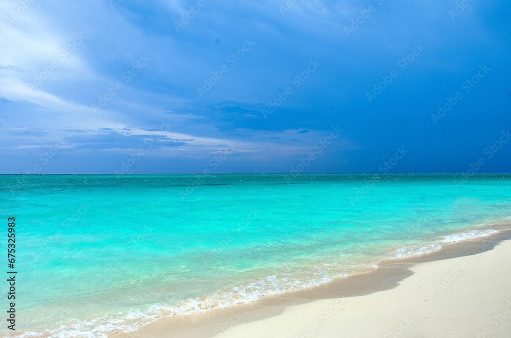 Sandy beach with pristine white sand against the crystal blue water