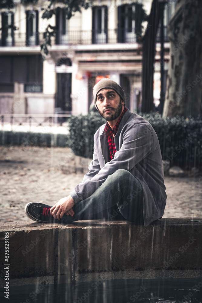 Tourist sitting in a fountain in the center of Madrid. Tourist sitting in a fountain in the center of Madrid.