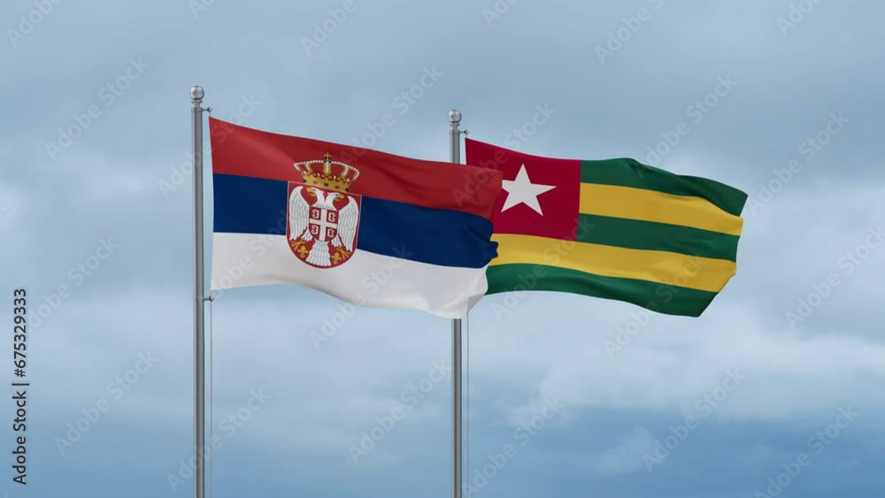 Togo, Togolese Republic and Serbia flag waving together on cloudy sky, endless seamless loop, two country cooperation concept Togo, Togolese Republic and Serbia flag waving together on cloudy sky, endless seamless loop, two country cooperation concept
