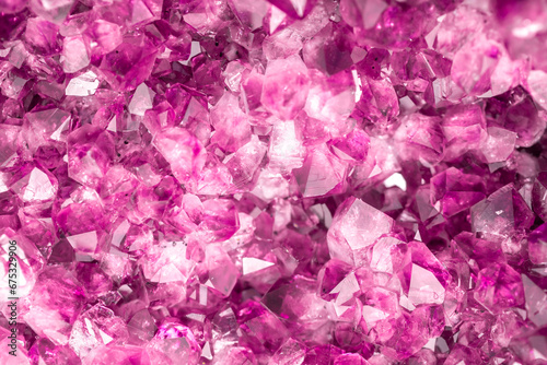 Amethyst pink crystals. Gems. Mineral crystals in the natural environment. Texture of precious and semiprecious stones. Seamless background with copy space colored shiny surface of precious stones. © Vera
