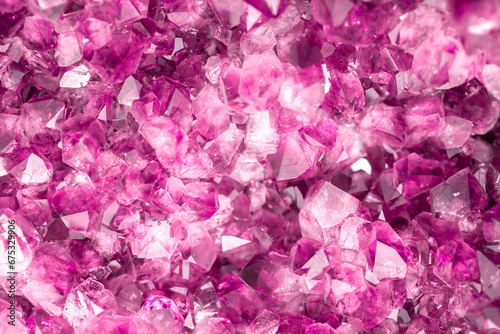 Amethyst pink crystals. Gems. Mineral crystals in the natural environment. Texture of precious and semiprecious stones. Seamless background with copy space colored shiny surface of precious stones.