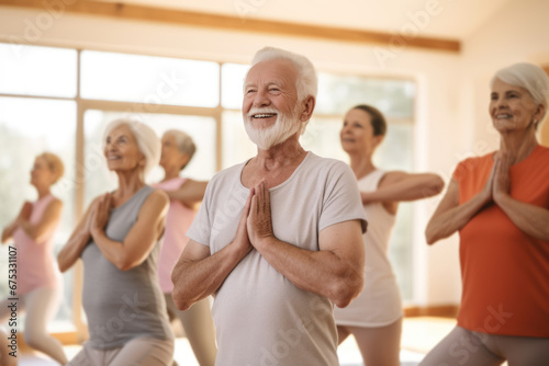 Group of active elderly people perform yoga together at a retreat center to improve their physical condition and well-being. Socialize with each other  active aging concept.