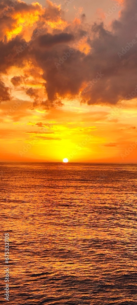 Vertical shot of golden sunset featuring a beautiful seashore of the North Sea