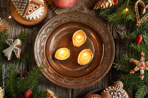Christmas nut candles floating in a bowl of water, top view